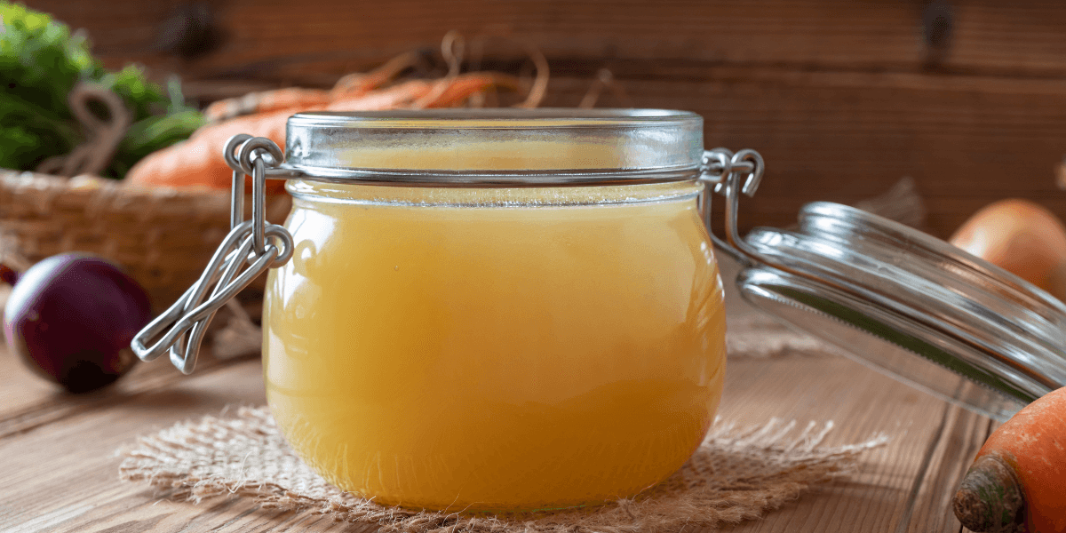 Vegan Chicken broth recipe or vegan chicken stock in a closed jar with recipe ingredients in the background.