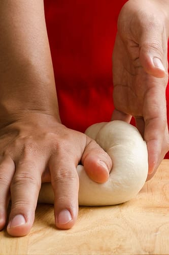 Punching homemade sourdough bread dough