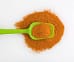 Homemade cajun seasoning recipe on a white background with a green portion scoop.