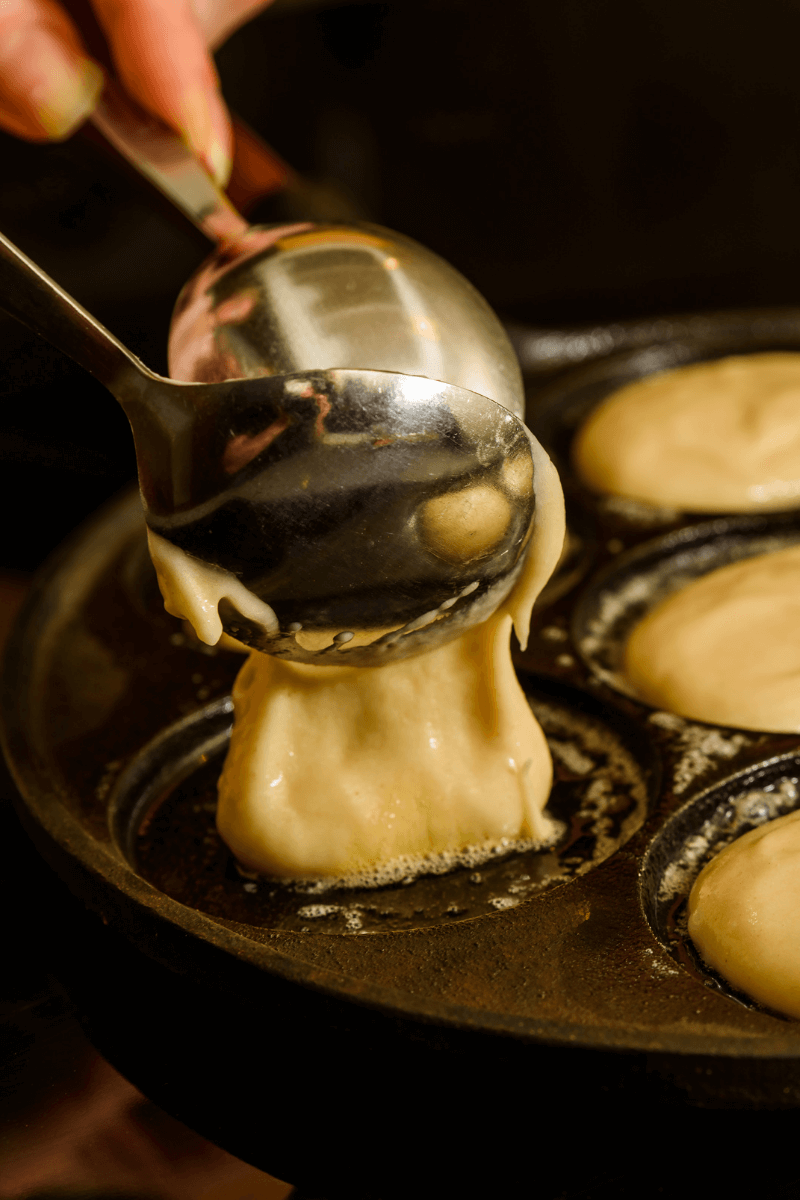 Homemade Vegan Pancakes Recipe: scooping batter into pancake pan.