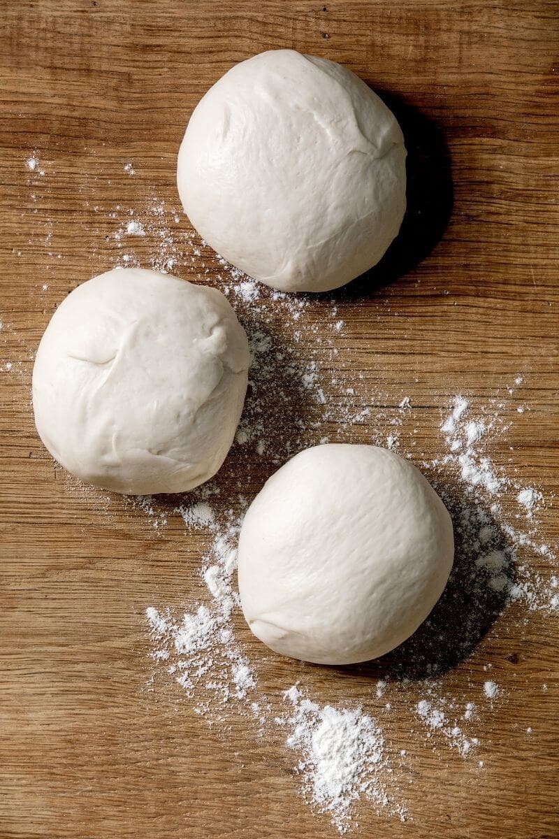 easy vegan pizza dough recipe that is  proofed and ready to be punched!