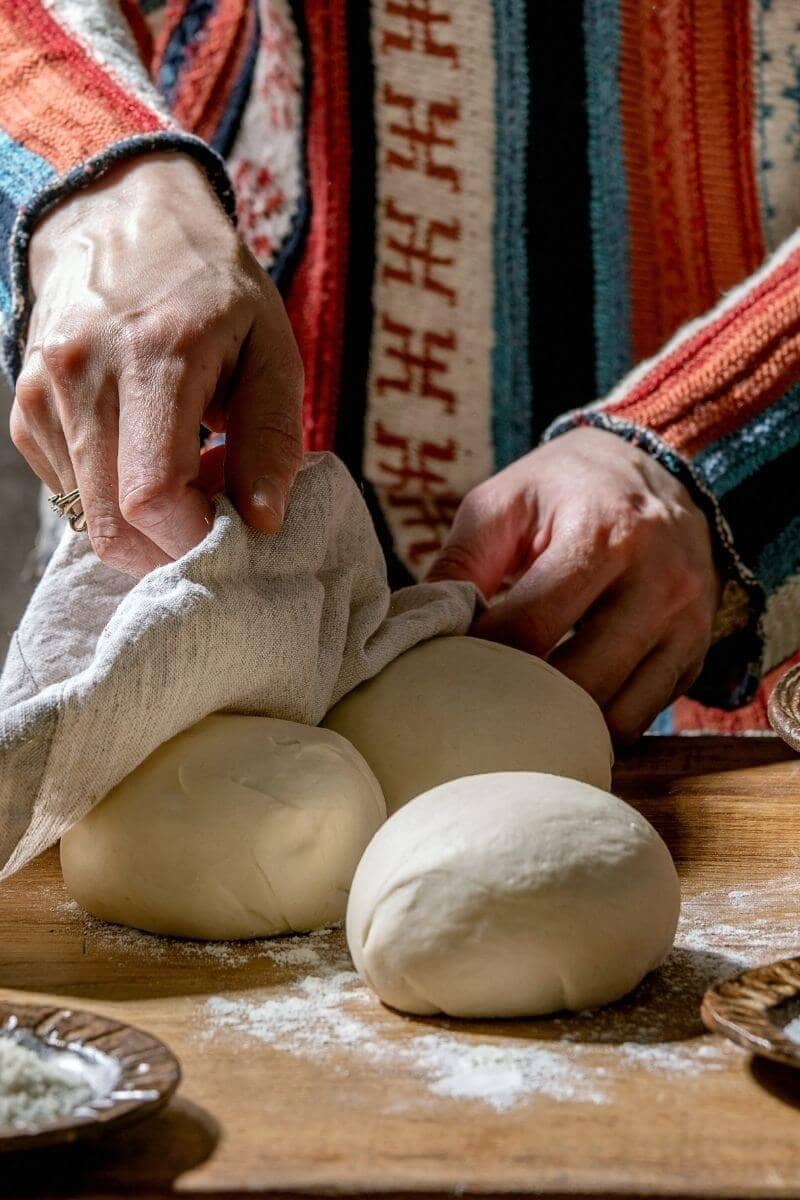 removing a cover from the easy vegan pizza dough recipe. 